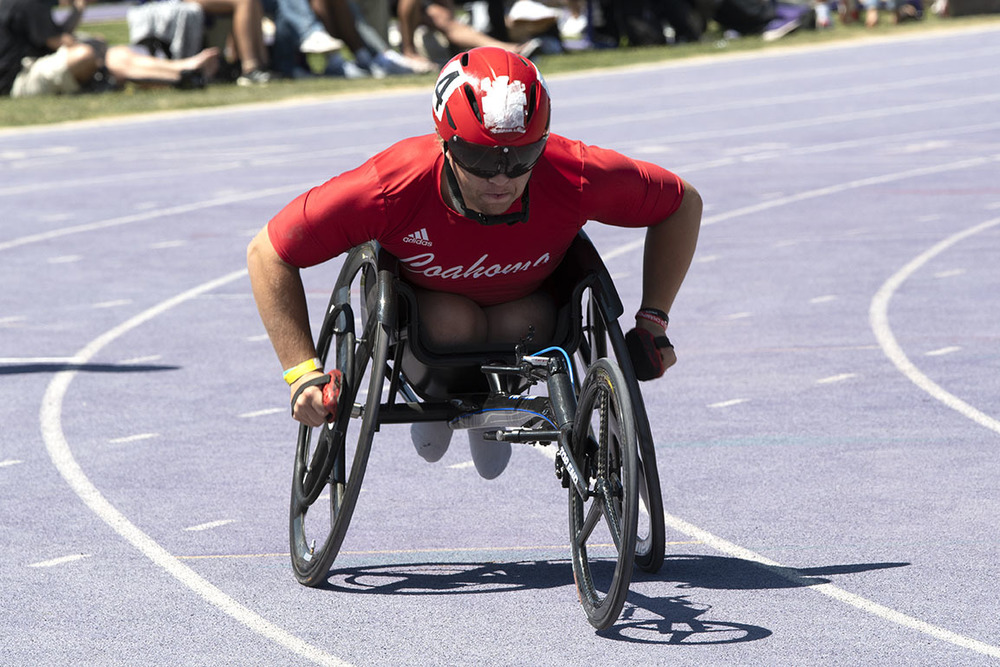 Youth in wheelchair racing in track meet
