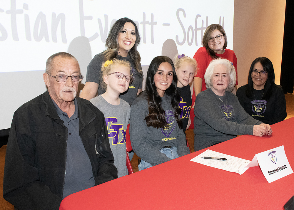 Family poses for a photo after a signing event