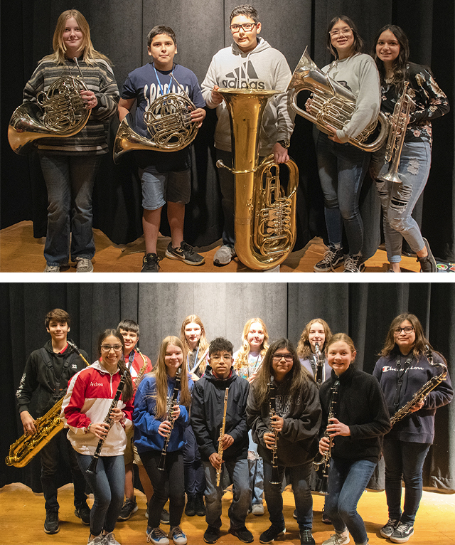 Band students posing for a photo with their instruments